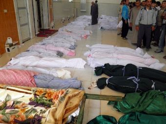 Тела убитых жителей Хулы перед захоронением. Фото ©AFP